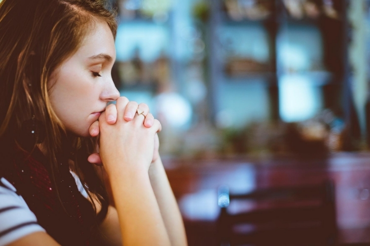 woman praying with humility